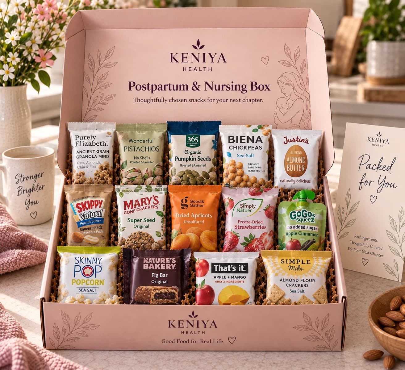 Example Postpartum & Nursing Box of 14 snacks: granola, pistachios, pumpkin seeds, roasted chickpeas, nut butter packs, seed crackers, dried apricots, freeze-dried strawberries, a fruit pouch, popcorn, a fig bar, a fruit bar and almond flour crackers