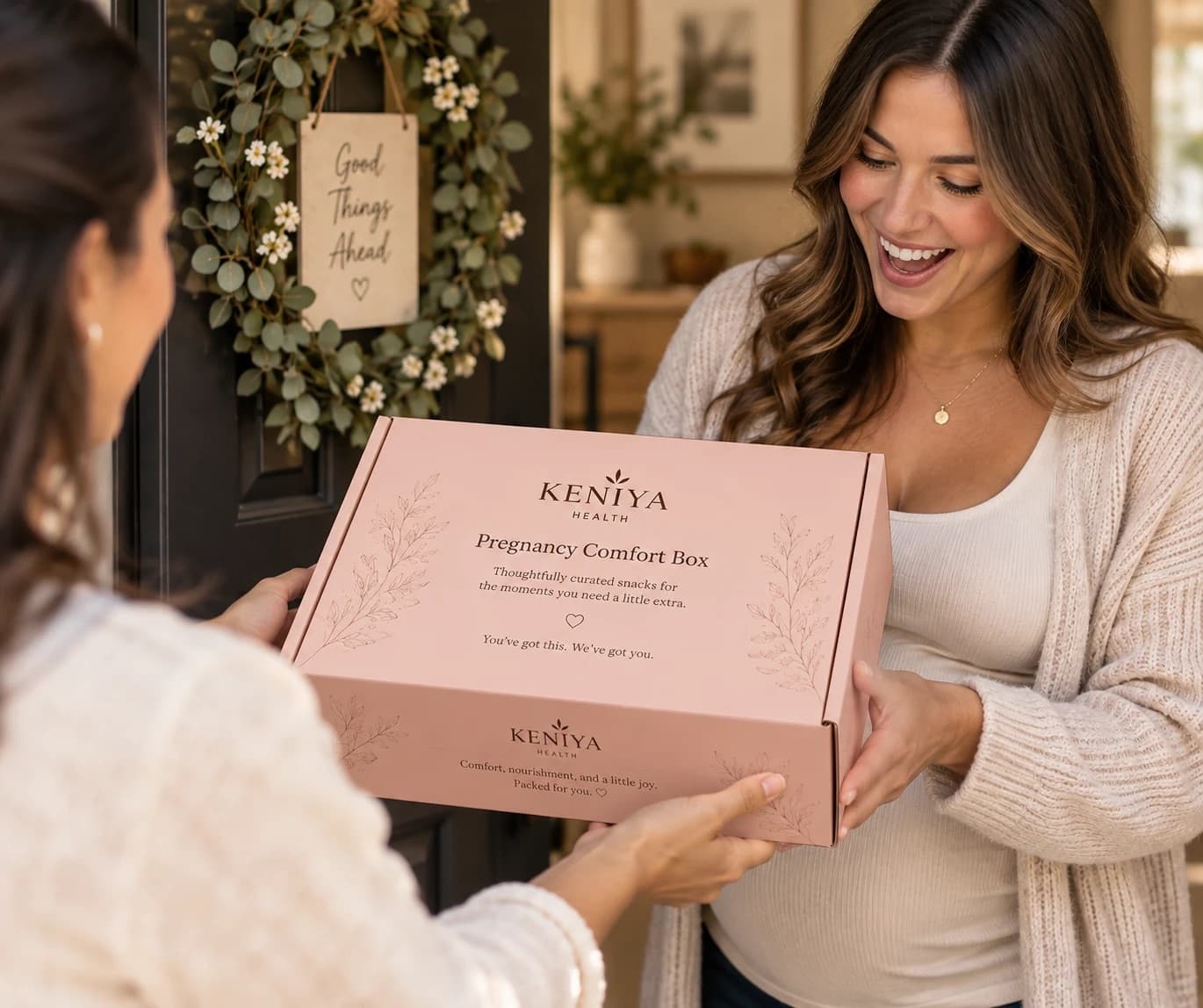 A smiling pregnant woman receiving a Keniya Pregnancy Comfort Box at her door